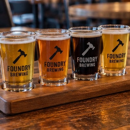 Custom brewery tasting glasses on a flight paddle